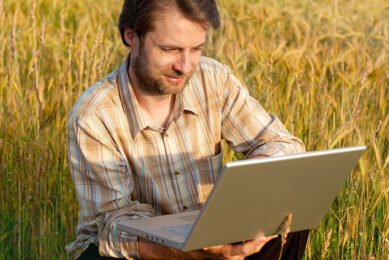 Happy smiling modern forty years old farmer checking his wheat field and working on laptop computer; Shutterstock ID 145449976; PO: AAF general