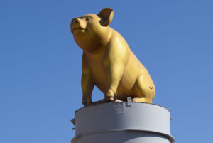 The company's landmark pig on top a pillar.