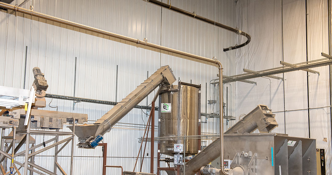 The augers move material from the de-packager to blenders and mixers to create specific blends before the drying process. Photo: Bright Feeds